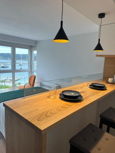 a kitchen with a wooden counter with two plates on it at Apartamento Plaza Este in Muxia