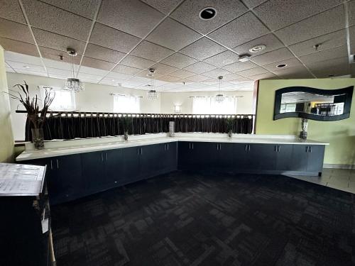 a large empty room with a long table in it at Best Western Little River Inn in Simcoe