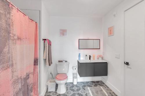 a bathroom with a pink toilet and a sink at Pink Heaven in Elizabeth