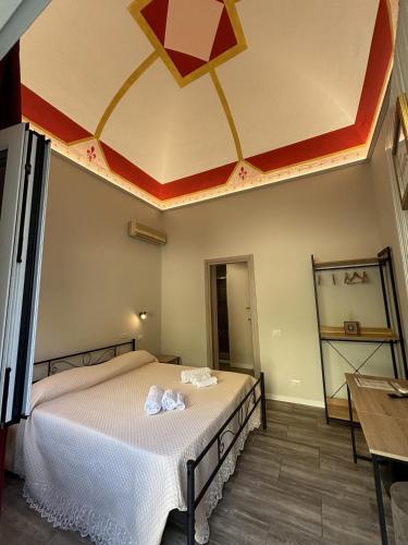 a bedroom with a large bed with a ceiling at Domus Divina in Cefalù