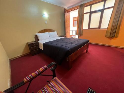 Кровать или кровати в номере HOSTAL HUAYNA HOUSE GO