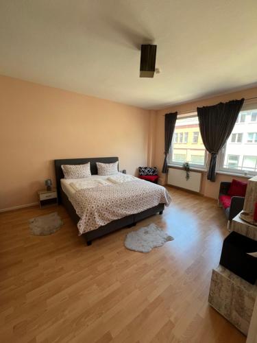 a bedroom with a bed and a large window at Innenstadt Lübeck Ferienwohnung in Lübeck
