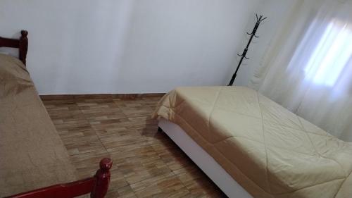 a bedroom with a bed and a window at Casas boa vista in Campos do Jordão