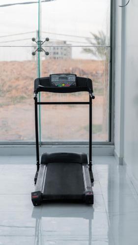 a treadmill sitting in front of a window at شقق زائر الشمال للشقق المخدومة in Hail