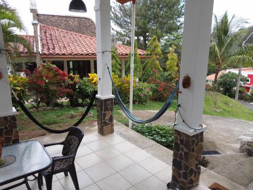 a porch with a rope attached to a house at Luxurious private room with bathroom in mountaine in Sorá