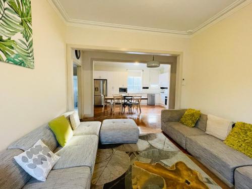 a living room with two couches and a table at D108 Fantastic Sun Crescent Gathering in Sunshine