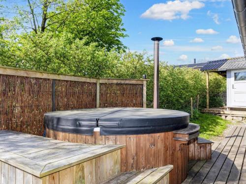 a hot tub in a backyard with a wooden fence at 6 person holiday home in Højslev-By Traum in Højslev