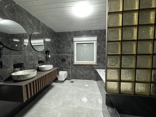 a bathroom with two sinks and a tub at Lux apartments Crystal-center in Bihać