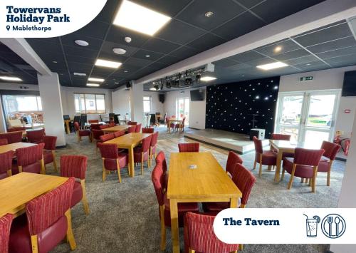 a dining room with wooden tables and chairs at Towervans Holiday Park in Mablethorpe