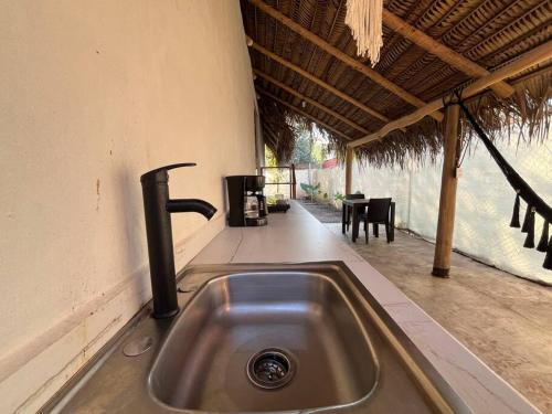a kitchen sink in a house with a patio at Casa Lorinda in Lo de Marcos