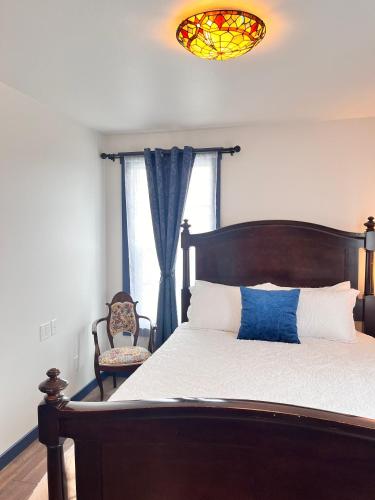 a bedroom with a bed and a stained glass window at Werner Room 204, Hyland Hotel in Palmer