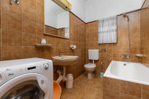a bathroom with a washing machine and a sink at Apartments by the sea Drasnice, Makarska - 2722 in Drasnice
