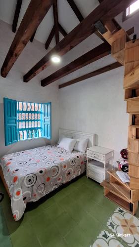 a bedroom with a large bed and a window at Villa Linda ApartaHotel in Jericó