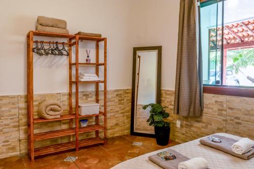 a room with two beds and a mirror at Bella casa da paz in Búzios