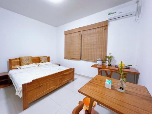 a bedroom with a bed and a table at Grand Leone Hotel in Freetown