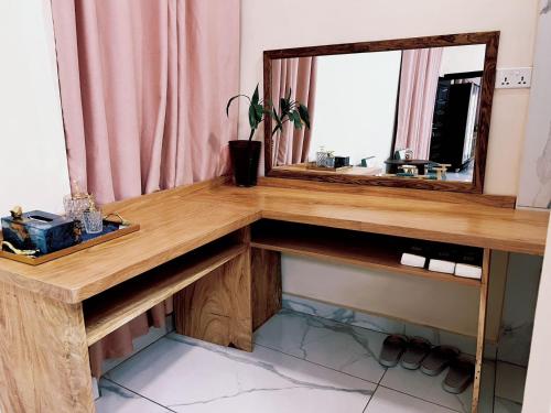 a wooden counter with a mirror and a sink at Grand Leone Hotel in Freetown