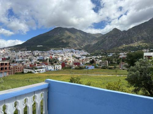 a view of a city from a balcony with mountains at Duplex panoramique avec jardin in Chefchaouene
