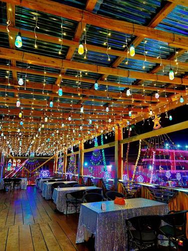 a dining room with tables and christmas lights at Grand Leone Hotel in Freetown