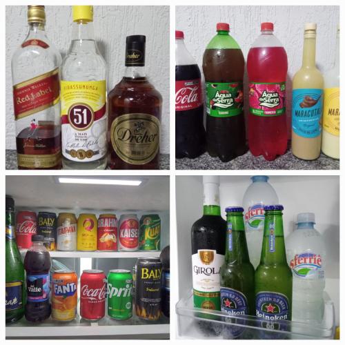 a refrigerator filled with lots of different types of drinks at POUSADA ALTERNATIVA MANU LAGES Quarto Com Banheiro no Corredor in Lages