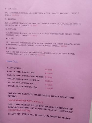 a close up of a pink paper with writing on it at POUSADA ALTERNATIVA MANU LAGES Quarto Com Banheiro no Corredor in Lages