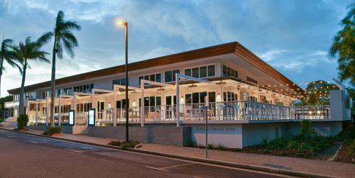 a building with a balcony on the side of a street at Bargara Beach Hotel in Bargara