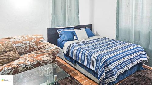 a bedroom with a bed and a glass table at Ces’t Lavie ultra apartments in Gros Islet