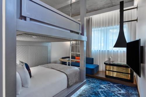 a bedroom with a bunk bed and a tv at W Aspen in Aspen