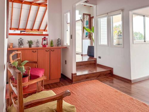 a living room with a table and a dining room at Kai Bed and Breakfast in Algarrobo