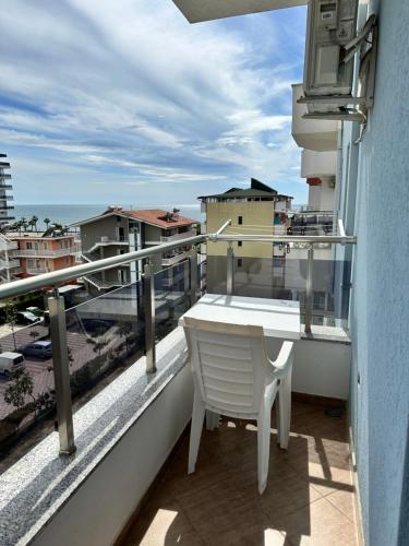 a balcony with a table and a view of a city at Hotel Ersi in Shëngjin
