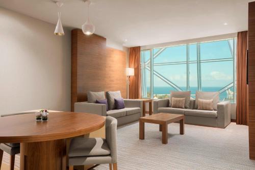 a living room with a table and a couch at Sheraton Annaba Hotel in Annaba