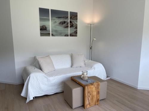 a white room with a bed and a table at Ferienwohnung Hoherting in Prien am Chiemsee