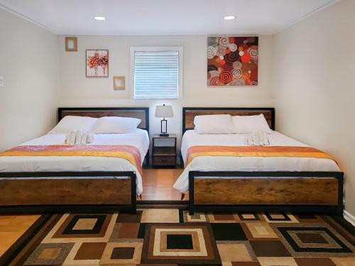 a bedroom with two beds and a rug at Modern Comfort Stays in Alexandria