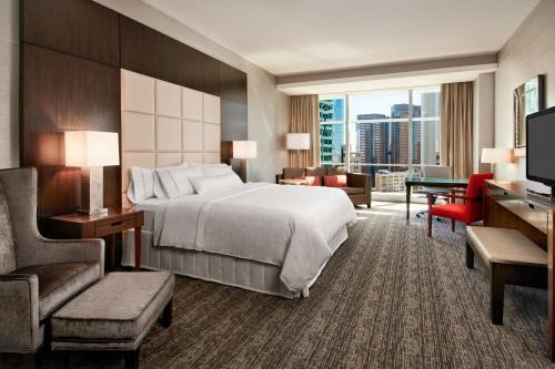 a large hotel room with a bed and a television at The Westin Phoenix Downtown in Phoenix