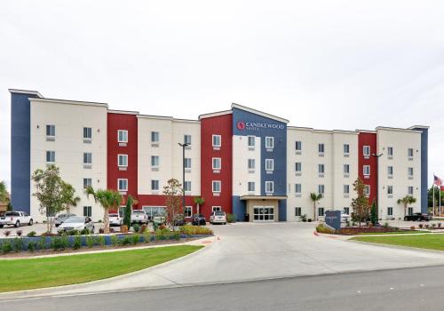 a row of buildings in a parking lot at Candlewood Suites DFW West - Hurst by IHG in Hurst