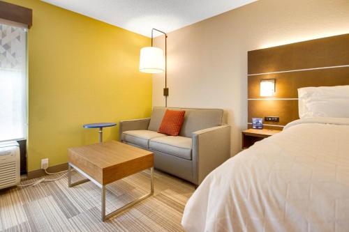 a hotel room with a bed and a chair at Holiday Inn Express Dublin by IHG in Dublin