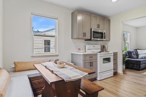 a living room with a table and a kitchen at Covered Patio With Grill Affordable Comfy Stay in Rapid City