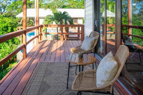 two chairs and a table on a porch at Apricari Villa / Luxury Views / 5 BDRM / Pool in Roatan
