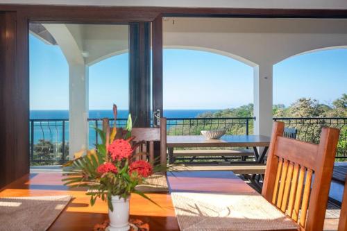 a dining room with a table and views of the ocean at Apricari Villa / Luxury Views / 5 BDRM / Pool in Roatan