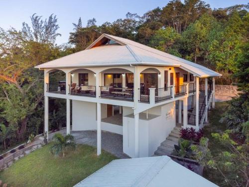 an aerial view of a house with a porch at Apricari Villa / Luxury Views / 5 BDRM / Pool in Roatan