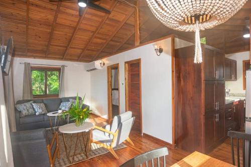 a living room with a couch and a table at Apricari Villa / Luxury Views / 5 BDRM / Pool in Roatan