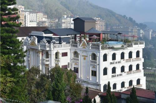 a large white building on top of a mountain at Sapa Nature View Hotel in Sa Pa