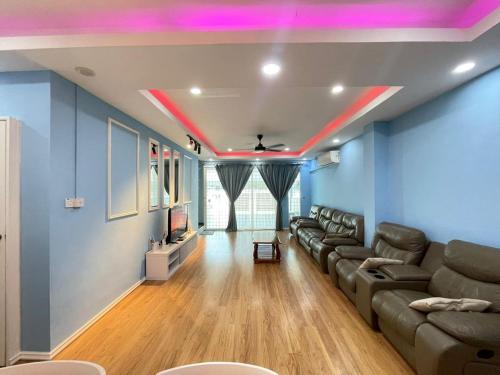 a living room with a couch and a tv at Lisa Homestay Sandakan in Sandakan