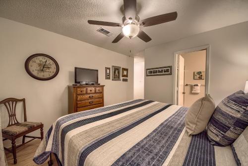 a bedroom with a bed with a ceiling fan and a clock at CRC 317 Timeless Tranquility in New Braunfels