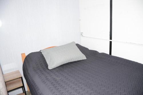 a bedroom with a bed with a pillow on it at Mi linda casa de campo in Nocaima
