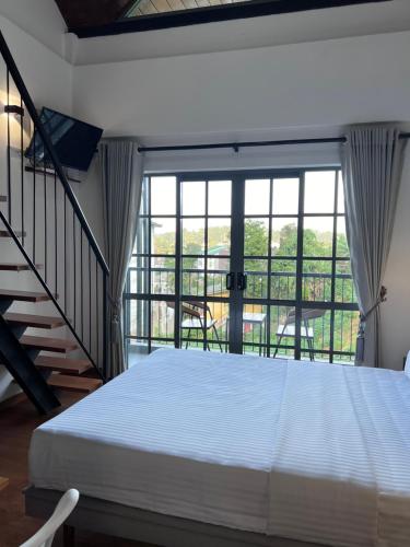 a bedroom with a large bed and a balcony at 88th Nuwara Eliya in Nuwara Eliya