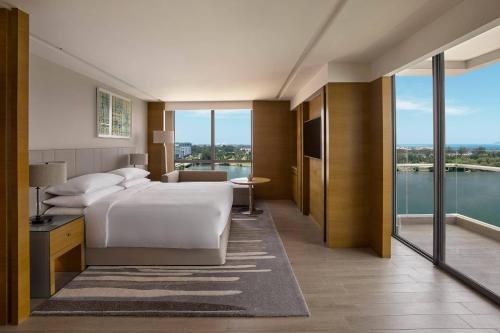 Schlafzimmer mit einem Bett und Blick auf das Wasser in der Unterkunft Kota Kinabalu Marriott Hotel in Kota Kinabalu