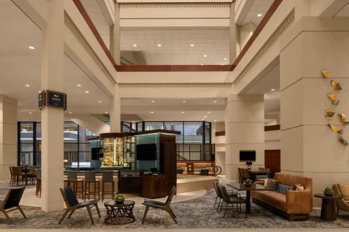 a lobby of a hotel with chairs and tables at Des Moines Marriott Downtown in Des Moines
