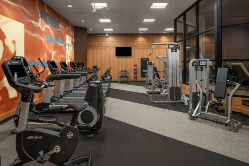 a gym with rows of treadms and cardio machines at Des Moines Marriott Downtown in Des Moines