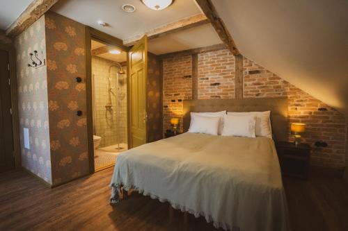 a bedroom with a bed and a walk in shower at Amante Boutique in Kuressaare