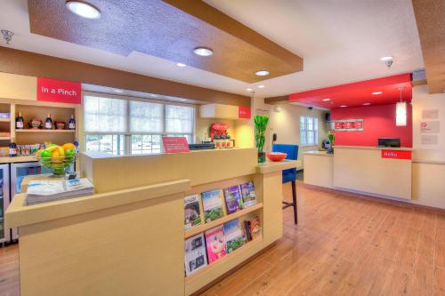 a lobby of a store with a counter with books at TownePlace Suites Raleigh Cary/Weston Parkway in Cary